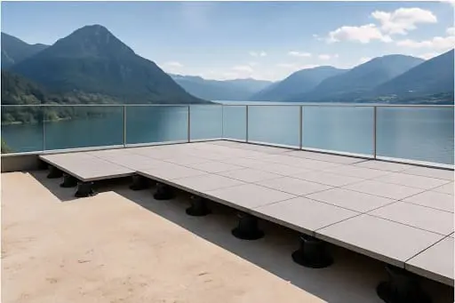 SkyJack fully assembled paver pedestal being set on rooftop deck